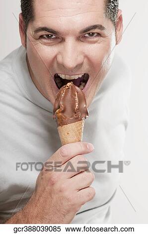 Portrait of a man eating an ice cream cone View Large Photo Image Stock Photography - Portrait of a man eating an ice cream cone. Fotosearch