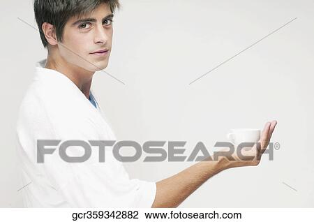 Portrait of a man holding a cup of coffee View Large Photo Image Stock Image - Portrait of a man holding a cup of coffee. Fotosearch