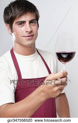 Portrait of a man holding a glass of red wine View Large Photo Image Stock Image - Portrait of a man holding a glass of red wine. Fotosearch