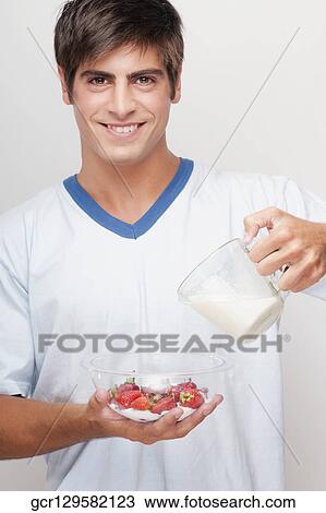 Portrait of a man pouring milk on strawberries View Large Photo Image Stock Image - Portrait of a man pouring milk on strawberries. Fotosearch