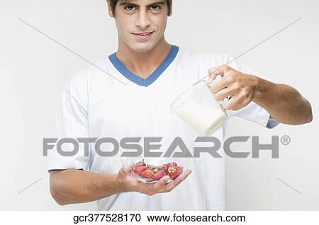 Portrait of a man pouring milk on strawberries View Large Photo Image Stock Image - Portrait of a man pouring milk on strawberries. Fotosearch