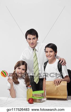 Portrait of a man with his children ready to go to school View Large Photo Image Stock Image - Portrait of a man with his children ready to go to school. Fotosearch