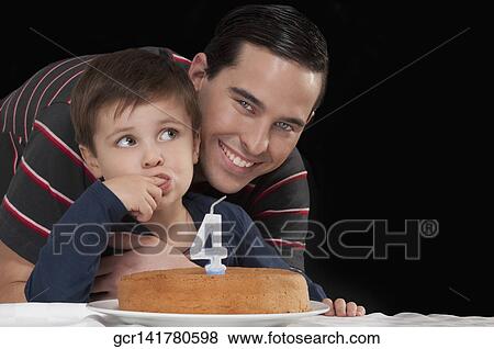 Portrait of a man with his son behind a birthday cake View Large Photo Image Stock Photo - Portrait of a man with his son behind a birthday cake. Fotosearch