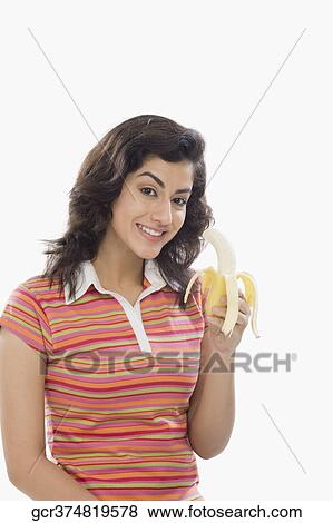 Portrait of a woman eating a banana View Large Photo Image Stock Photo - Portrait of a woman eating a banana. Fotosearch