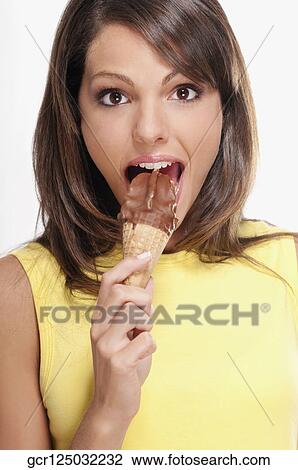 Portrait of a woman eating a chocolate ice cream View Large Photo Image Stock Image - Portrait of a woman eating a chocolate ice cream. Fotosearch