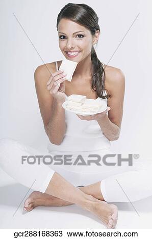 Stock Image - Portrait of a woman eating a sandwich. Fotosearch