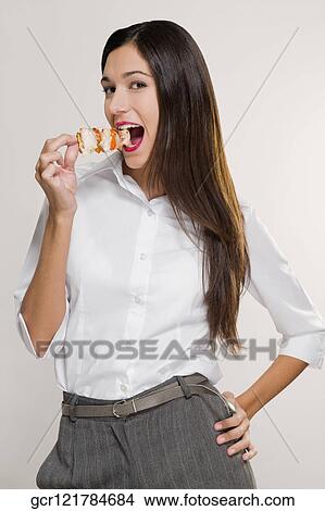 Portrait of a woman eating a shish kebab View Large Photo Image Picture - Portrait of a woman eating a shish kebab. Fotosearch