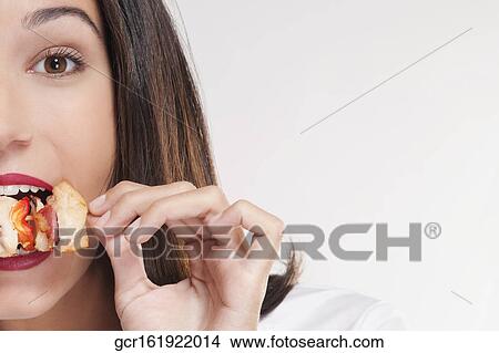 Picture - Portrait of a woman eating a shish kebab. Fotosearch