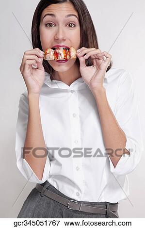 Portrait of a woman eating a shish kebab View Large Photo Image Stock Photo - Portrait of a woman eating a shish kebab. Fotosearch