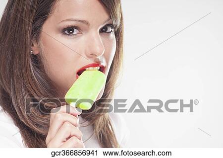 Portrait of a woman eating an ice lolly View Large Photo Image Stock Image - Portrait of a woman eating an ice lolly. Fotosearch