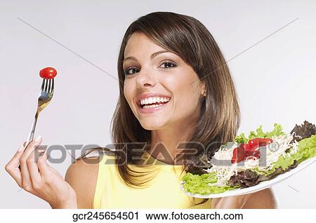 Portrait of a woman eating salad View Large Photo Image Stock Image - Portrait of a woman eating salad. Fotosearch