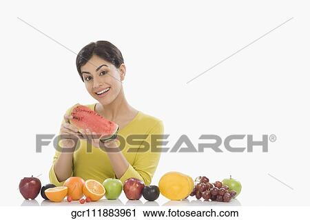 Portrait of a woman eating watermelon and smiling View Large Photo Image Stock Image - Portrait of a woman eating watermelon and smiling. Fotosearch