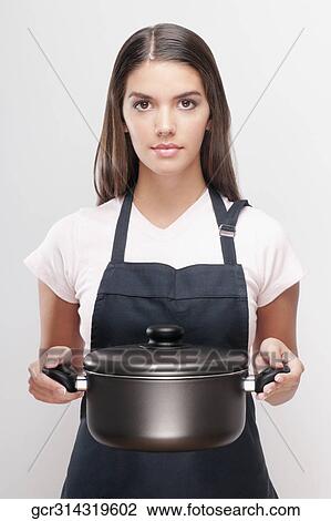 Portrait of a woman holding a crock pot View Large Photo Image Stock Image - Portrait of a woman holding a crock pot. Fotosearch