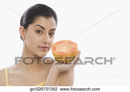 Portrait of a woman holding a half of papaya View Large Photo Image Stock Image - Portrait of a woman holding a half of papaya. Fotosearch
