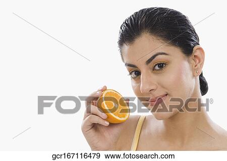 Portrait of a woman holding a half of orange View Large Photo Image Stock Photo - Portrait of a woman holding a half of orange. Fotosearch