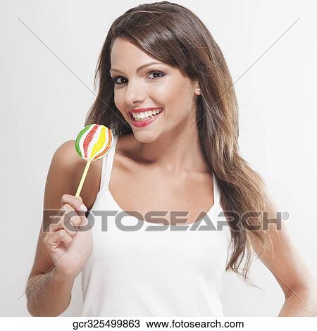 Portrait of a woman holding a lollipop View Large Photo Image Stock Image - Portrait of a woman holding a lollipop. Fotosearch