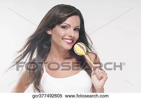 Portrait of a woman holding a lollipop View Large Photo Image Stock Photography - Portrait of a woman holding a lollipop. Fotosearch