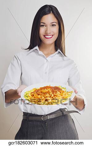 Portrait of a woman holding a platter of pasta View Large Photo Image Stock Image - Portrait of a woman holding a platter of pasta. Fotosearch