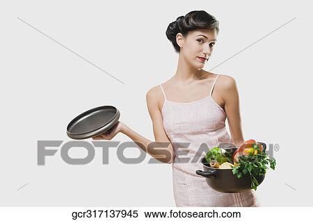 Portrait of a woman holding a pot of fresh vegetables View Large Photo Image Stock Photography - Portrait of a woman holding a pot of fresh vegetables. Fotosearch