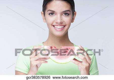 Portrait of a woman holding a watermelon slice View Large Photo Image Stock Photograph - Portrait of a woman holding a watermelon slice. Fotosearch