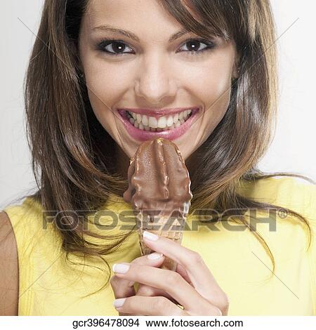 Portrait of a woman holding an ice cream cone View Large Photo Image Picture - Portrait of a woman holding an ice cream cone. Fotosearch
