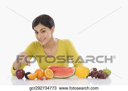 Portrait of a woman with a row of assorted fresh fruits View Large Photo Image Stock Image - Portrait of a woman with a row of assorted fresh fruits. Fotosearch