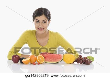 Portrait of a woman with a row of assorted fresh fruits View Large Photo Image Stock Photo - Portrait of a woman with a row of assorted fresh fruits. Fotosearch