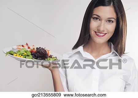 Portrait of a young woman holding a platter of shish kebabs View Large Photo Image Stock Photo - Portrait of a young woman holding a platter of shish kebabs. Fotosearch