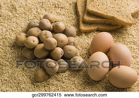 Raw potatoes with eggs and breads on brown rice View Large Photo Image Stock Photography - Raw potatoes with eggs and breads on brown rice. Fotosearch