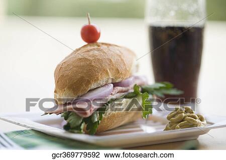 Salami sandwich served with cola View Large Photo Image Stock Image - Salami sandwich served with cola. Fotosearch