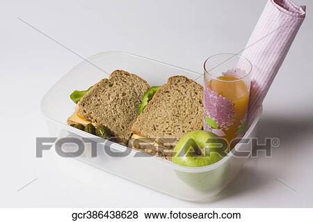 Stock Photo - Sandwiches with orange juice and green apple in a box. Fotosearch