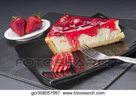 Stock Photo - Slice of strawberry cheesecake with strawberries and a fork. Fotosearch