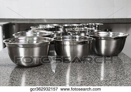Stainless steel bowls on a kitchen counter View Large Photo Image Stock Photo - Stainless steel bowls on a kitchen counter. Fotosearch