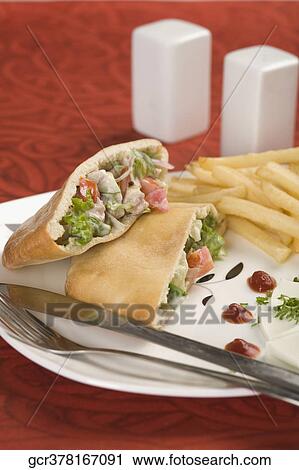 Stuffed pita sandwiches served with French fries View Large Photo Image Stock Image - Stuffed pita sandwiches served with French fries. Fotosearch