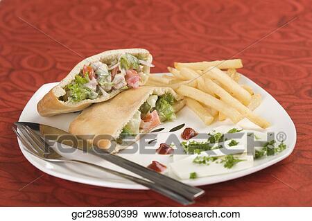 Stuffed pita sandwiches served with French fries View Large Photo Image Stock Photo - Stuffed pita sandwiches served with French fries. Fotosearch