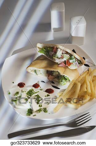 Stuffed pita sandwiches served with French fries View Large Photo Image Stock Photo - Stuffed pita sandwiches served with French fries. Fotosearch