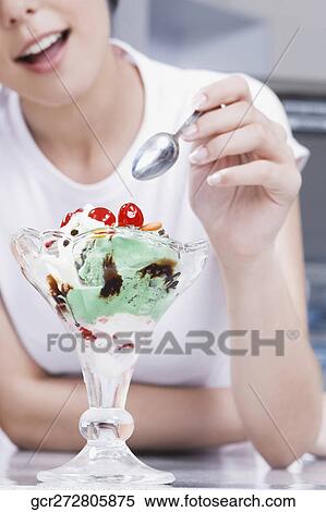 Teenage girl eating an ice cream in an ice cream parlor View Large Photo Image Stock Photography - Teenage girl eating an ice cream in an ice cream parlor. Fotosearch