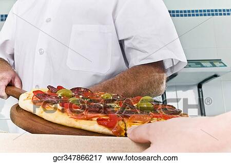 Two chefs preparing pizza in the kitchen View Large Photo Image Stock Photo - Two chefs preparing pizza in the kitchen. Fotosearch