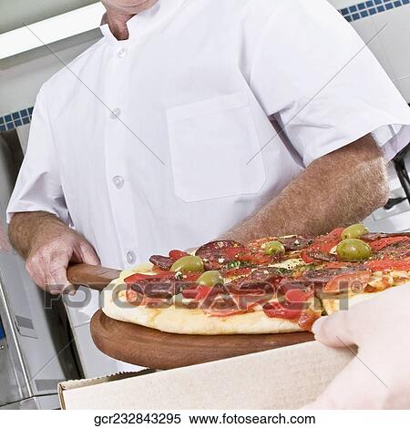 Two chefs preparing pizza in the kitchen View Large Photo Image Stock Photography - Two chefs preparing pizza in the kitchen. Fotosearch
