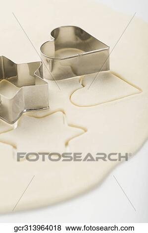 Stock Photo - Two pastry cutters on dough. Fotosearch