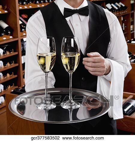 Waiter holding a tray of champagne flutes View Large Photo Image Stock Image - Waiter holding a tray of champagne flutes. Fotosearch