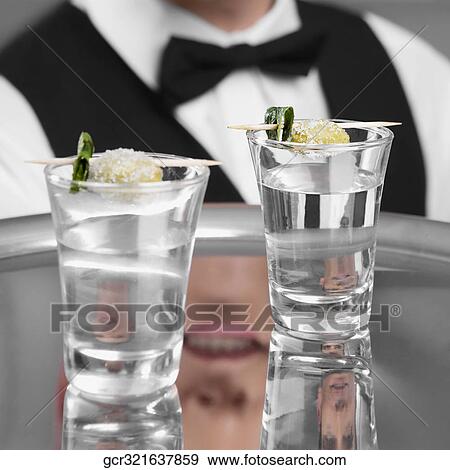 Waiter holding a tray of tequila shots View Large Photo Image Stock Photo - Waiter holding a tray of tequila shots. Fotosearch