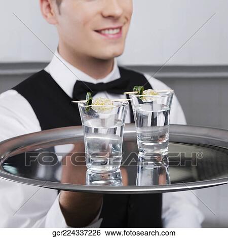 Waiter holding a tray of tequila shots View Large Photo Image Stock Photograph - Waiter holding a tray of tequila shots. Fotosearch