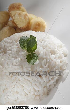 Stock Photo - White rice with fritters and basil leaves. Fotosearch