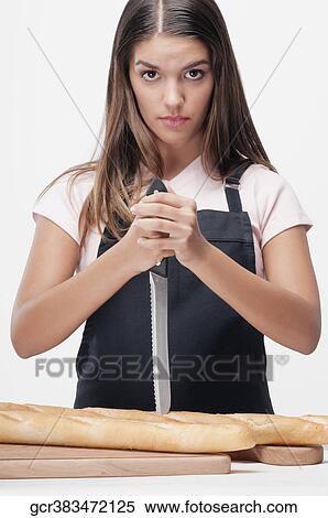 Woman cutting baguettes and thinking View Large Photo Image Stock Photography - Woman cutting baguettes and thinking. Fotosearch