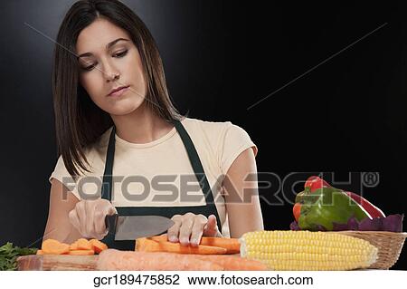 Woman cutting vegetables View Large Photo Image Stock Image - Woman cutting vegetables. Fotosearch