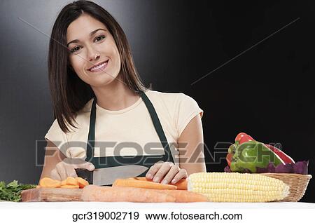 Woman cutting vegetables View Large Photo Image Stock Photo - Woman cutting vegetables. Fotosearch
