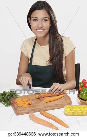 Woman cutting vegetables View Large Photo Image Stock Photograph - Woman cutting vegetables. Fotosearch