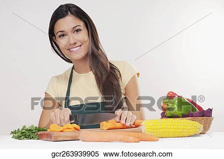 Woman cutting vegetables View Large Photo Image Stock Photography - Woman cutting vegetables. Fotosearch