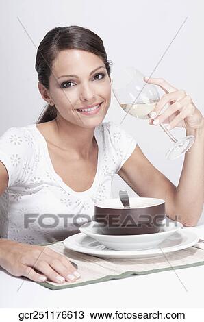 Woman drinking a glass of white wine and smiling View Large Photo Image Stock Image - Woman drinking a glass of white wine and smiling. Fotosearch